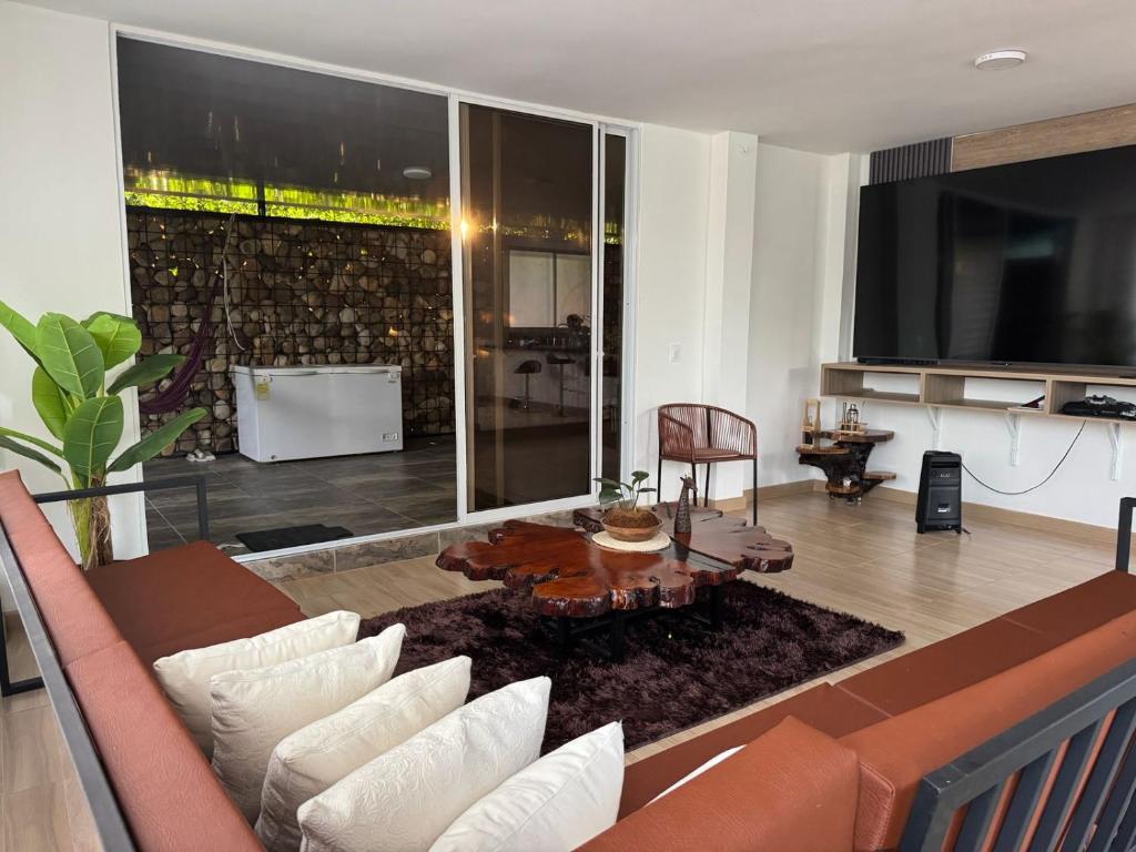 a living room with a couch and a table at El Chaparral in Yopal