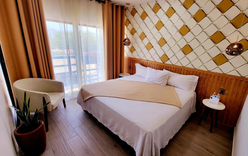 a hotel room with a bed and a window at Hotel Casa Jima Agave in Tequila
