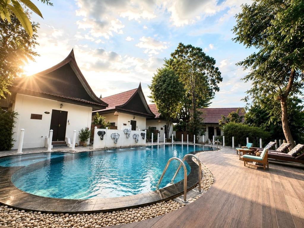 a swimming pool in front of a house at Pludhaya Resort & Spa in Phra Nakhon Si Ayutthaya