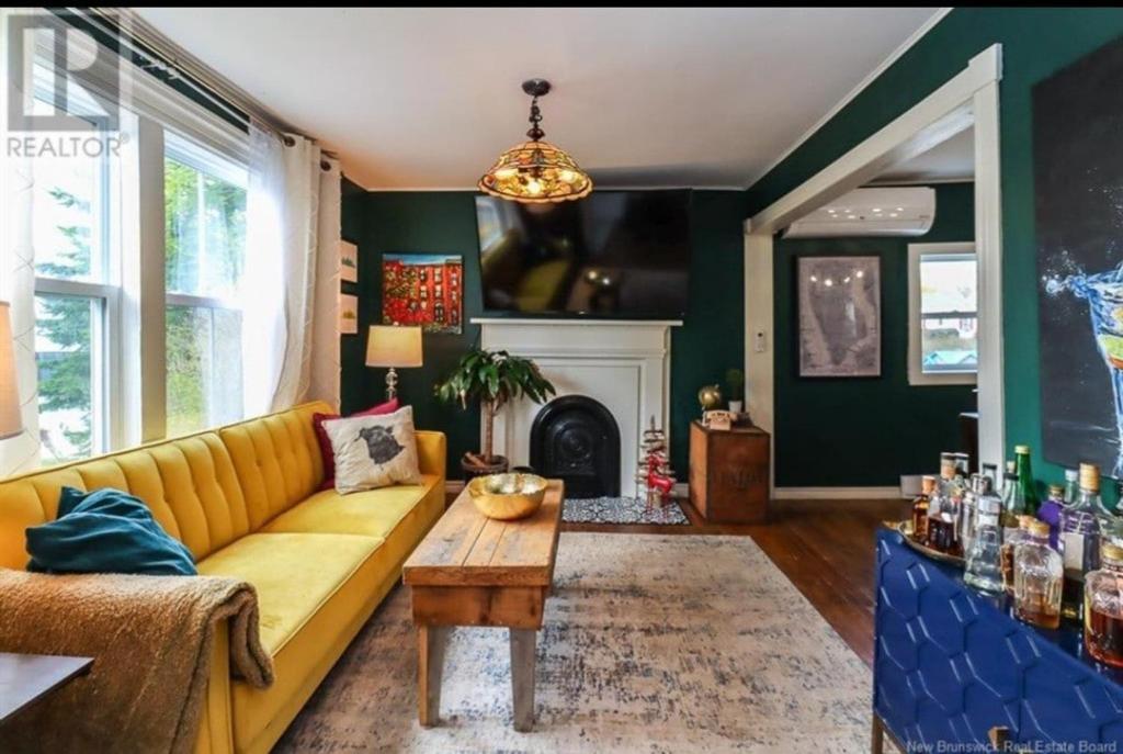 a living room with a yellow couch and a fireplace at Central, Dog Friendly, Parking in Saint John