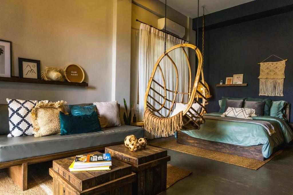 a living room with a couch and a large fan at Happiness Villas in El Nido