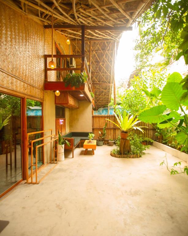 a lobby of a building with a lot of plants at Happiness Native Villa in El Nido