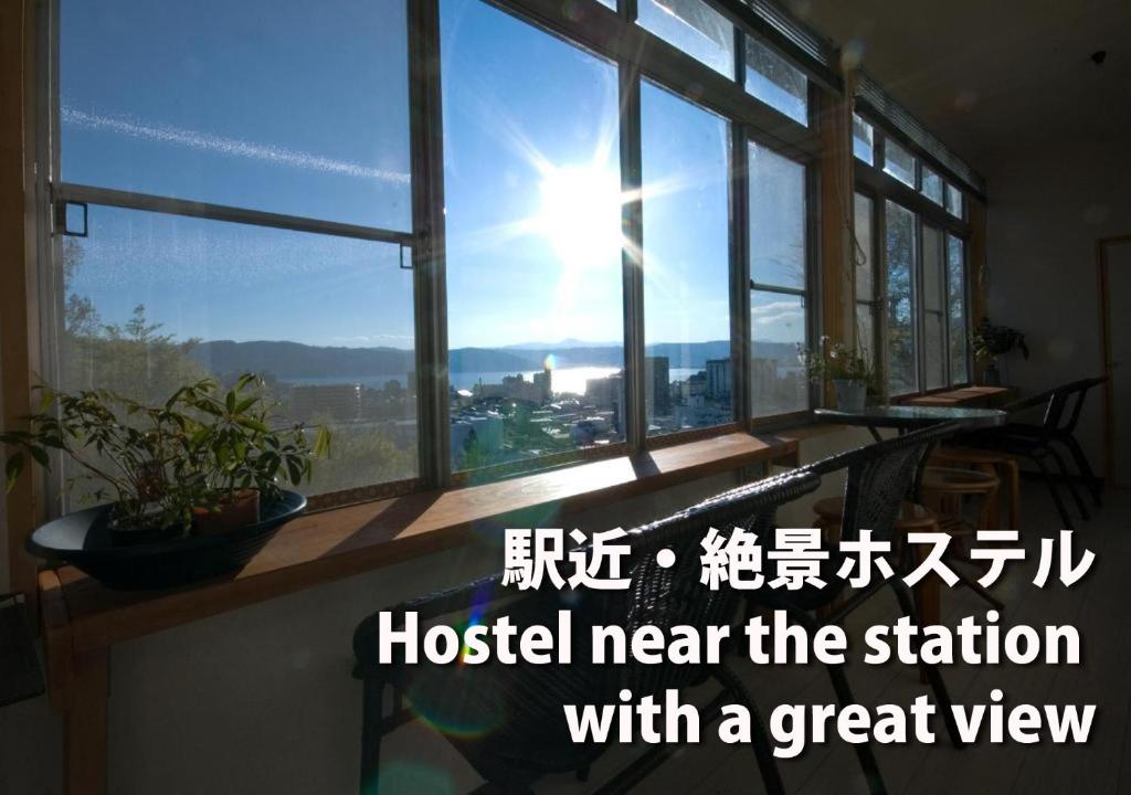 a window with the words hostel near the station with a great view at Chambre dhote Tatami in Suwa