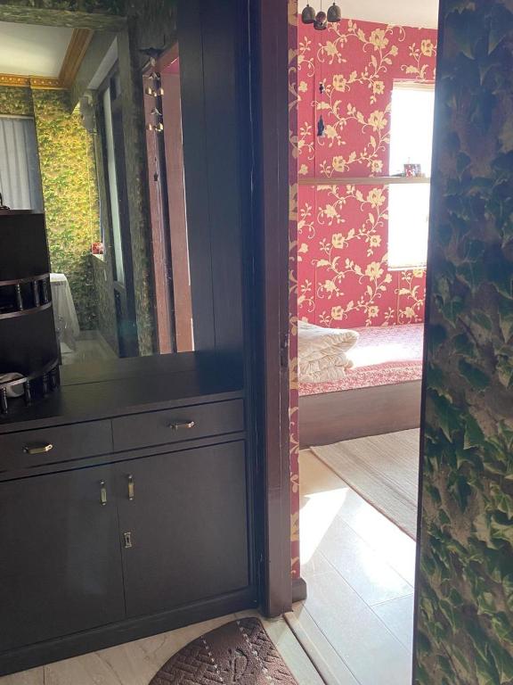 a room with a dresser with a mirror and a bedroom at Soaltee city apartments in Kathmandu