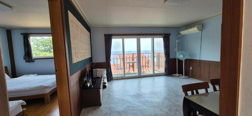 a room with a bedroom with a bed and a window at Stay something in Ch'ŏnbu-ri