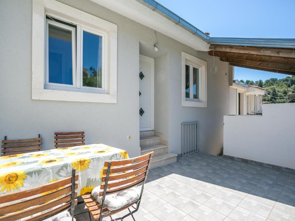 a house with a table and chairs on a patio at Alluring Apartment by the Sea in Stomorska