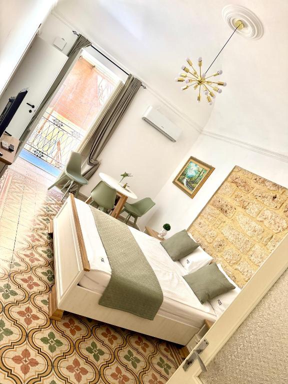 a bedroom with a large bed and a large window at Appartamenti Tiffany & Timi in Carini