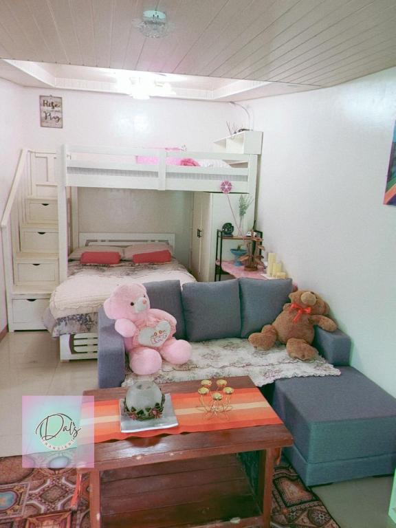 a room with a couch and two bunk beds at Dals Accommodation pad in Baguio