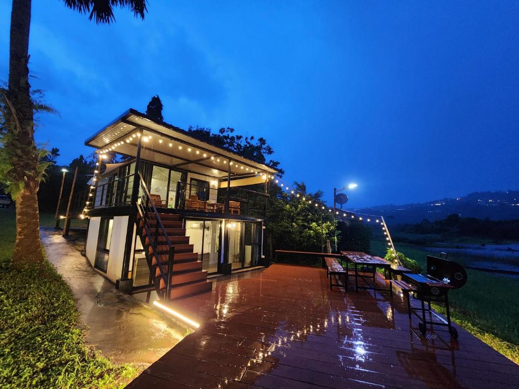 a small house with a deck at night at Porjai's Lakeview in Phetchabun