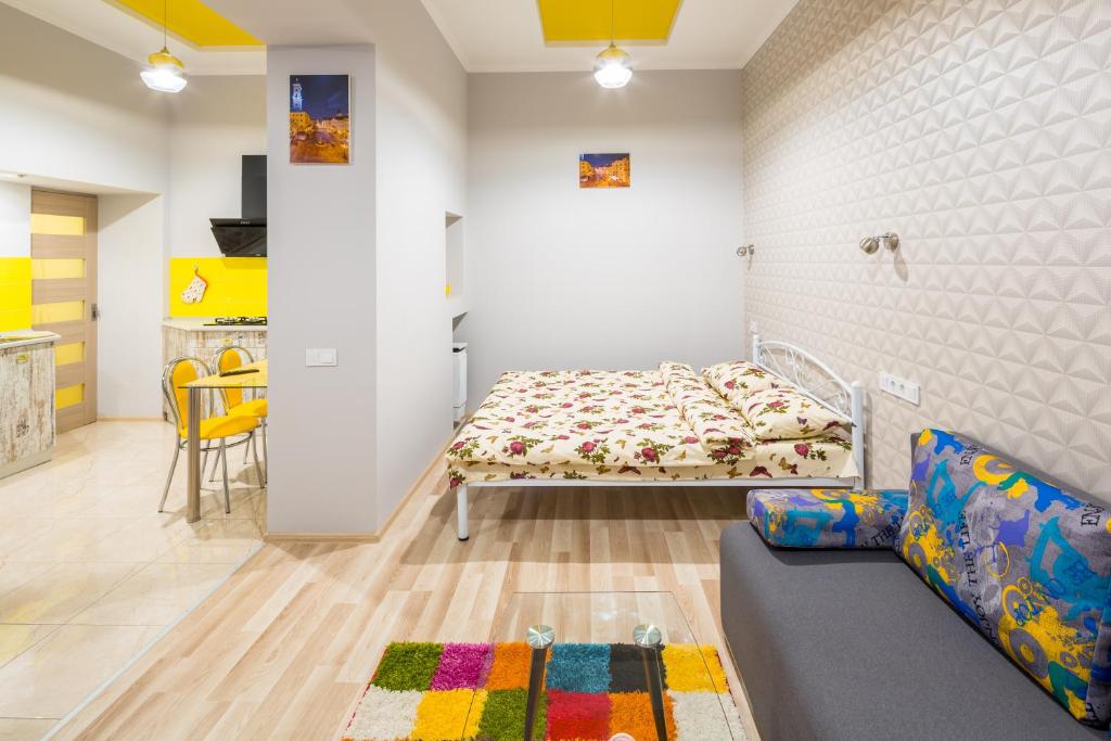 a bedroom with a bed and a couch in a room at Apartment on Pekarska street зі світлом! in Lviv