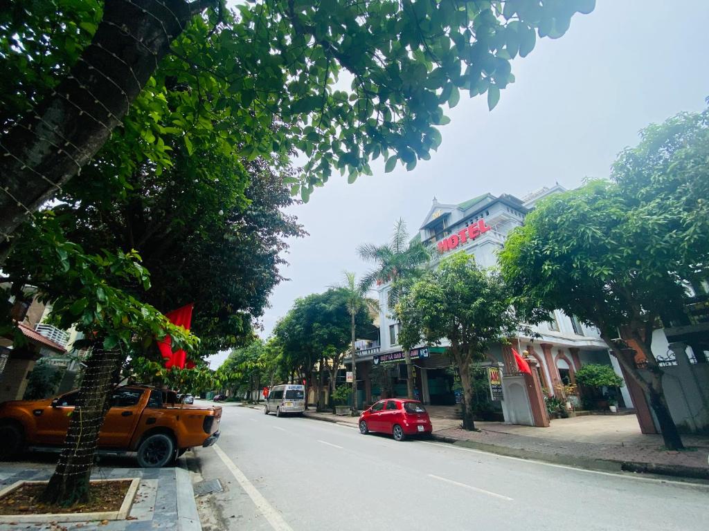 a small red car parked on the side of a street at Khách sạn AMI in Vinh