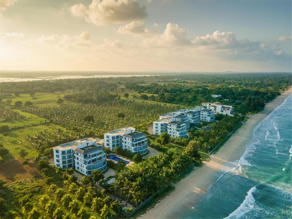 an aerial view of the beach and the ocean at Oceanfront Condos Nilaveli by ICC in Nilaveli
