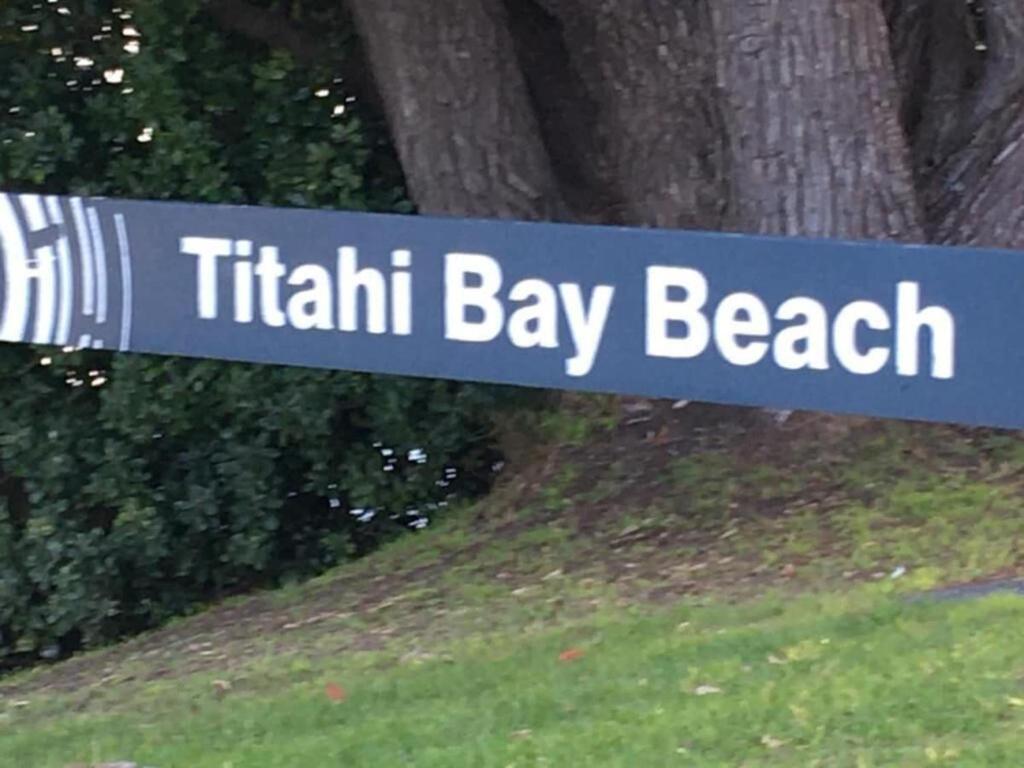 a blue and white sign that readsfifth bay beach at Relaxing Beach Side House in Porirua