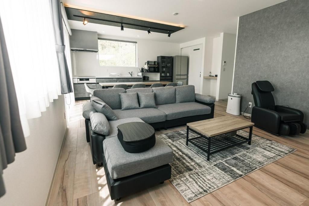 a living room with a couch and a table at AOI Villa Biei in Biei