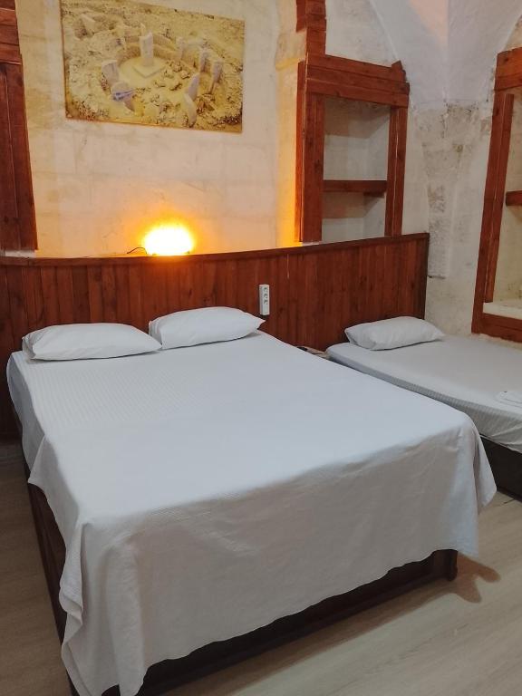 a couple of beds in a room at Alkan mozayik otel in Urfa
