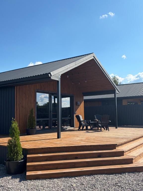a building with a deck with a table and chairs at СвояХата in Svityazʼ