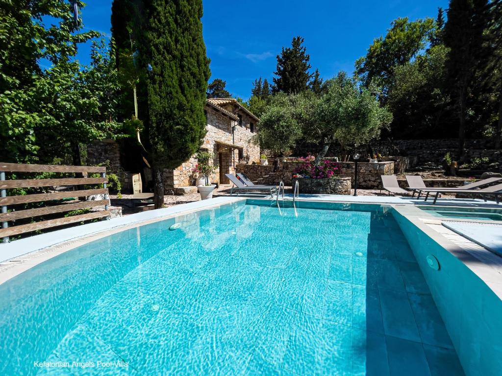 a swimming pool in front of a house at Kefalonian Luxury Villas in Kástron