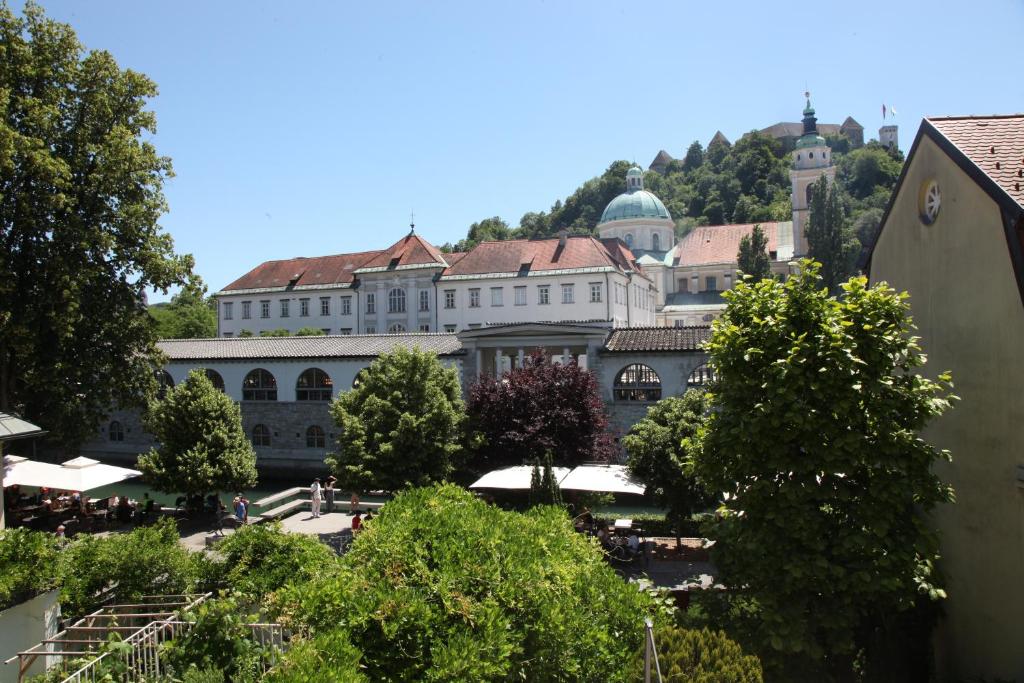 a large building with trees in front of it at The sanctuary ljubljana in Ljubljana
