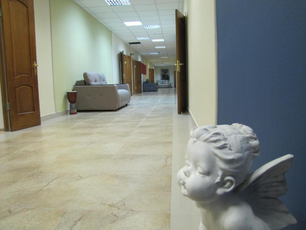 a statue of a cherubs head in a hallway at Hostel Bravo in Irkutsk
