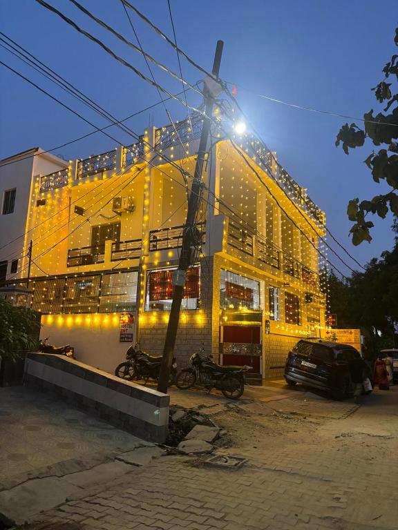 a yellow building with bikes parked in front of it at RAMRAJ GUEST House in Ayodhya