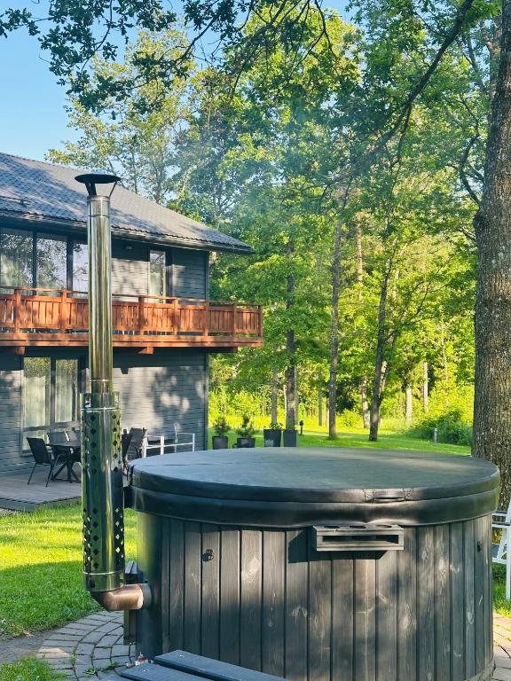a hot tub in the backyard of a house at Brīvdienu māja Sniegi in Madona