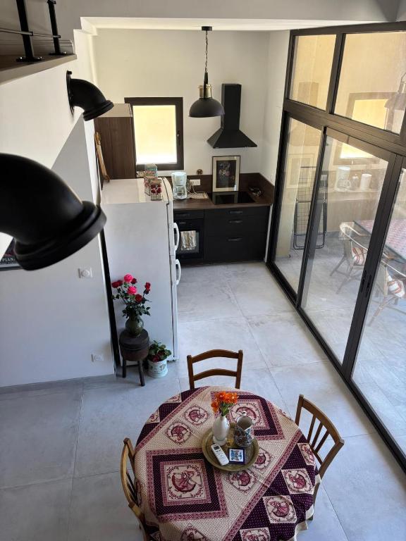 a dining room with a table and a refrigerator at Charming loft in Cozzano in Cozzano