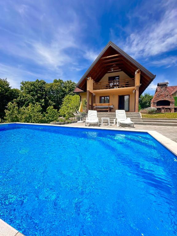 a house with a swimming pool in front of a house at Foresta Home in Gradačac