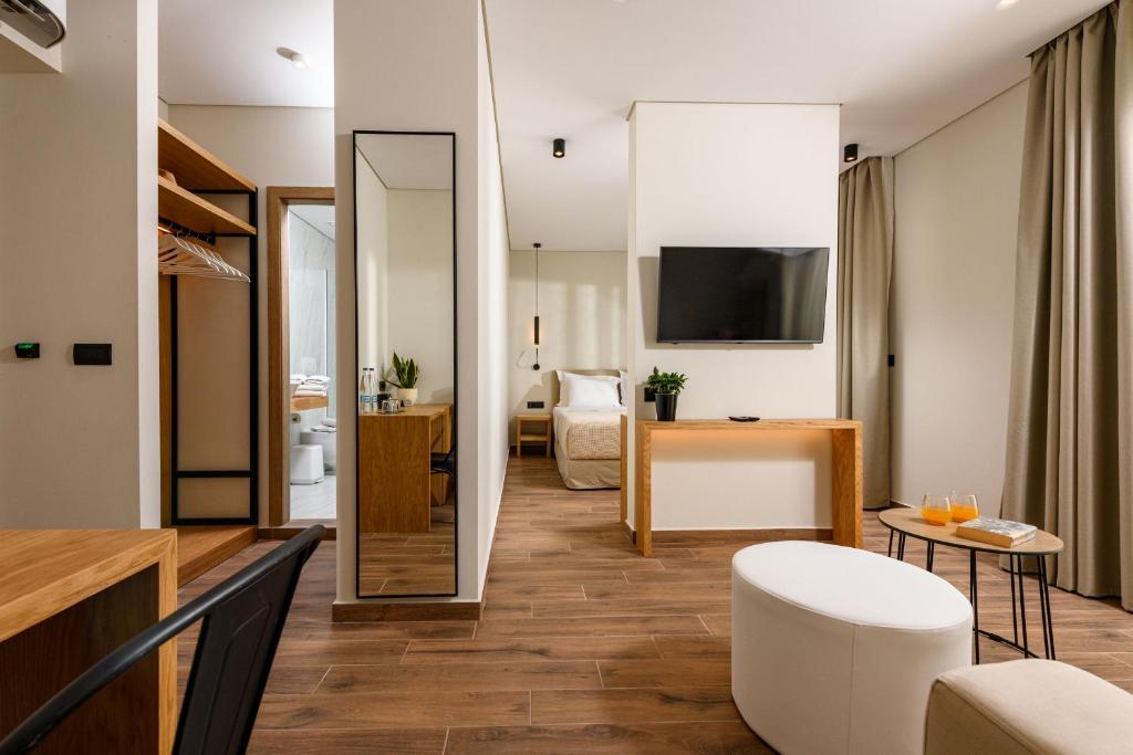 a living room with a large mirror and a living room at Mary Hotel in Limenas