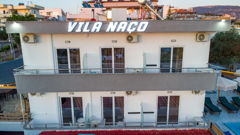 a boat in the water with a sign that reads villa magro at Vila Naço Ksamil in Ksamil