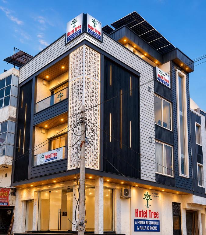 a building with a clock tower on top of it at Hotel Tree in Hisār