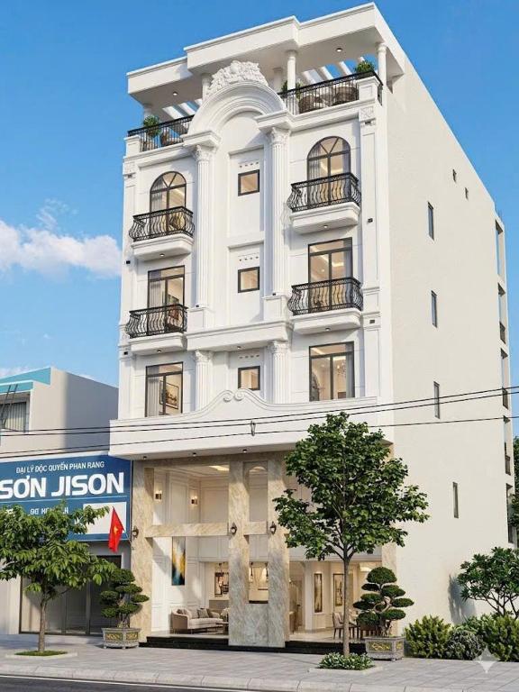 a tall white building with windows and balconies at Khách Sạn Anh Khoa 2 in Phan Rang–Tháp Chàm