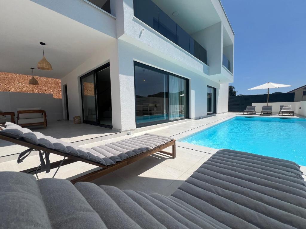 a villa with a swimming pool and a house at Villa Artemis III in Žman