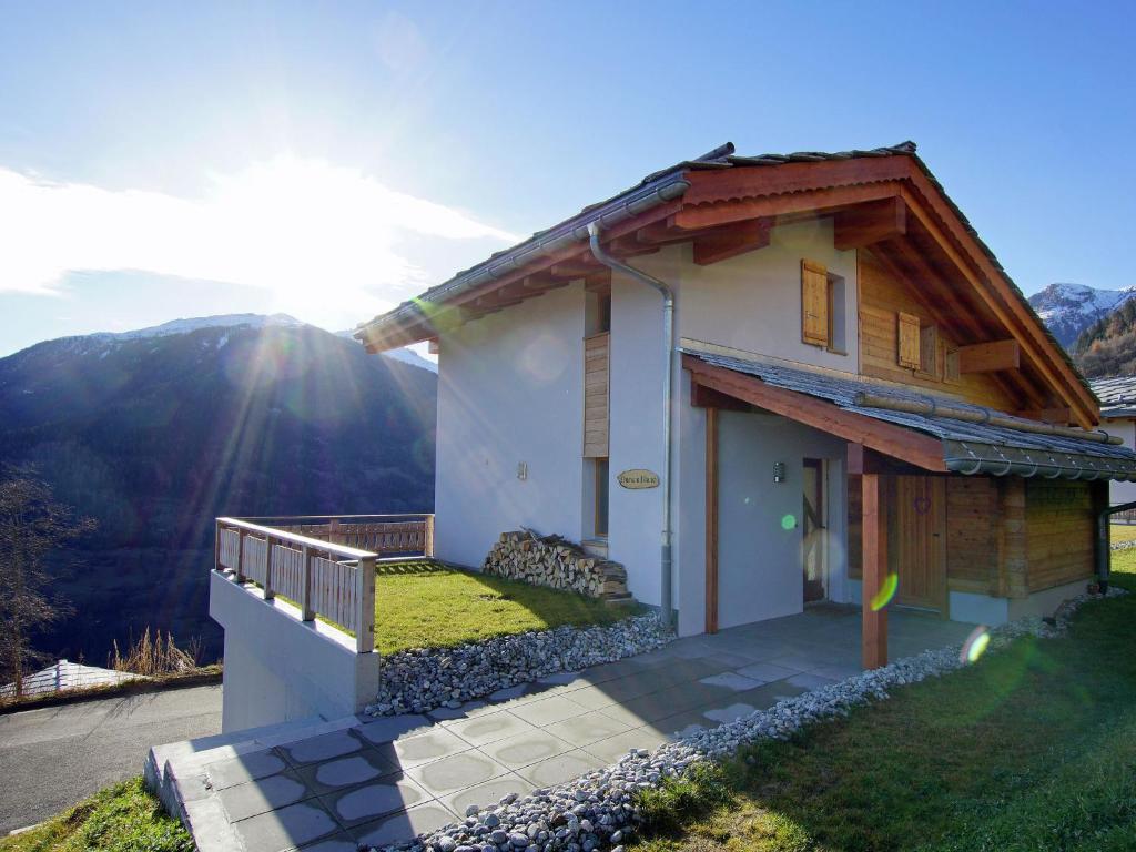 a house with a view of a mountain at Charming Private Bungalow in Wohlenberg on Natural Beach in Hérémence