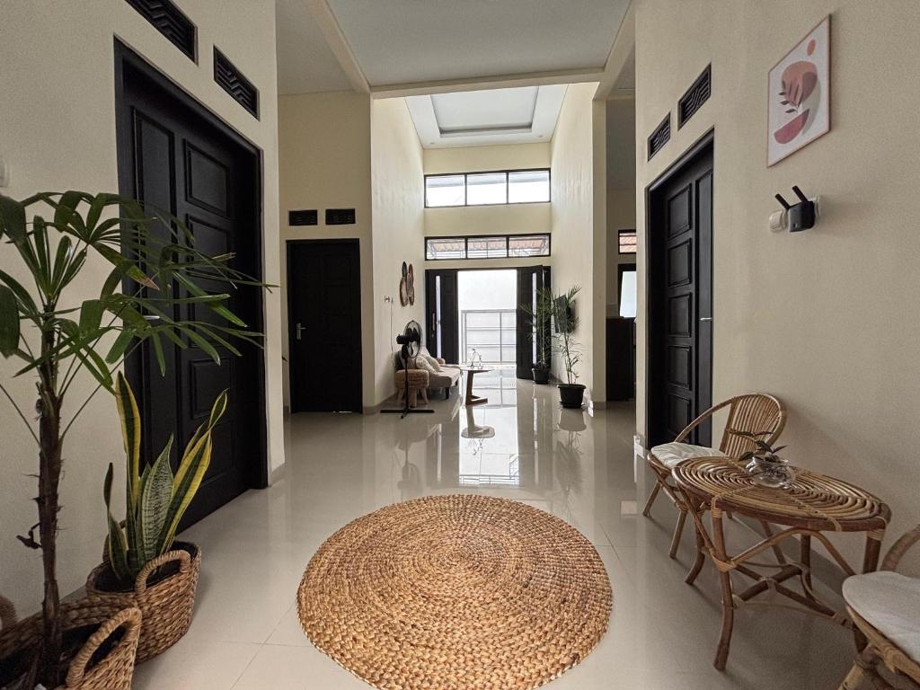 a hallway with a table and chairs and a rug at Secretspot Yogyakarta in Yogyakarta