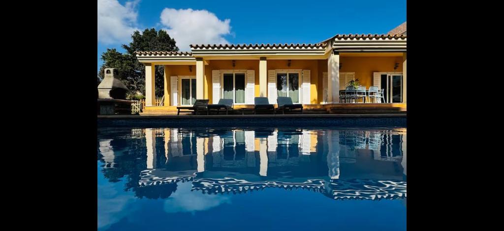 a house with a pool of water in front of it at Villa Ramón in Palma de Mallorca
