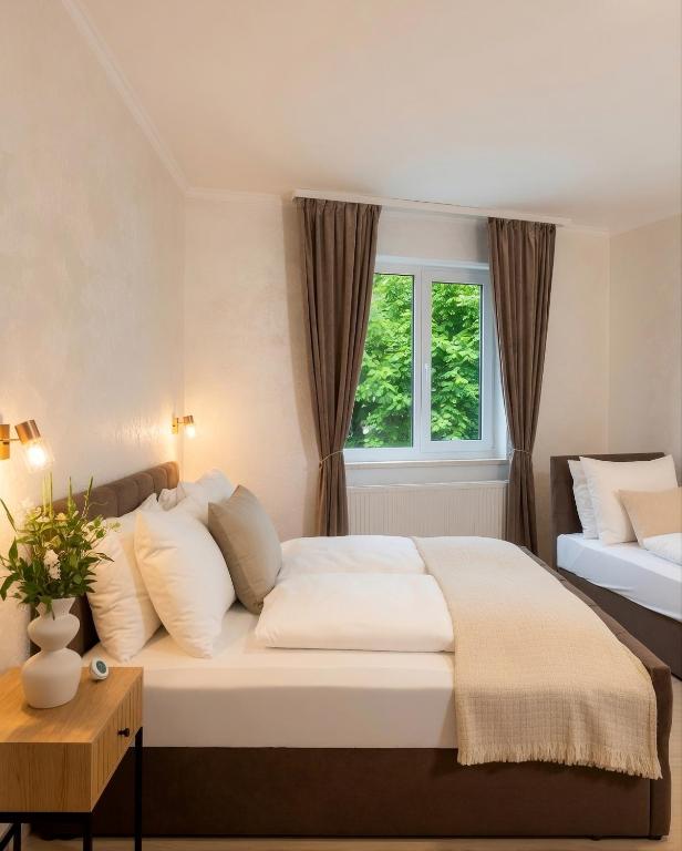 a bedroom with a large bed and a window at Zemlinsky Hof in Payerbach