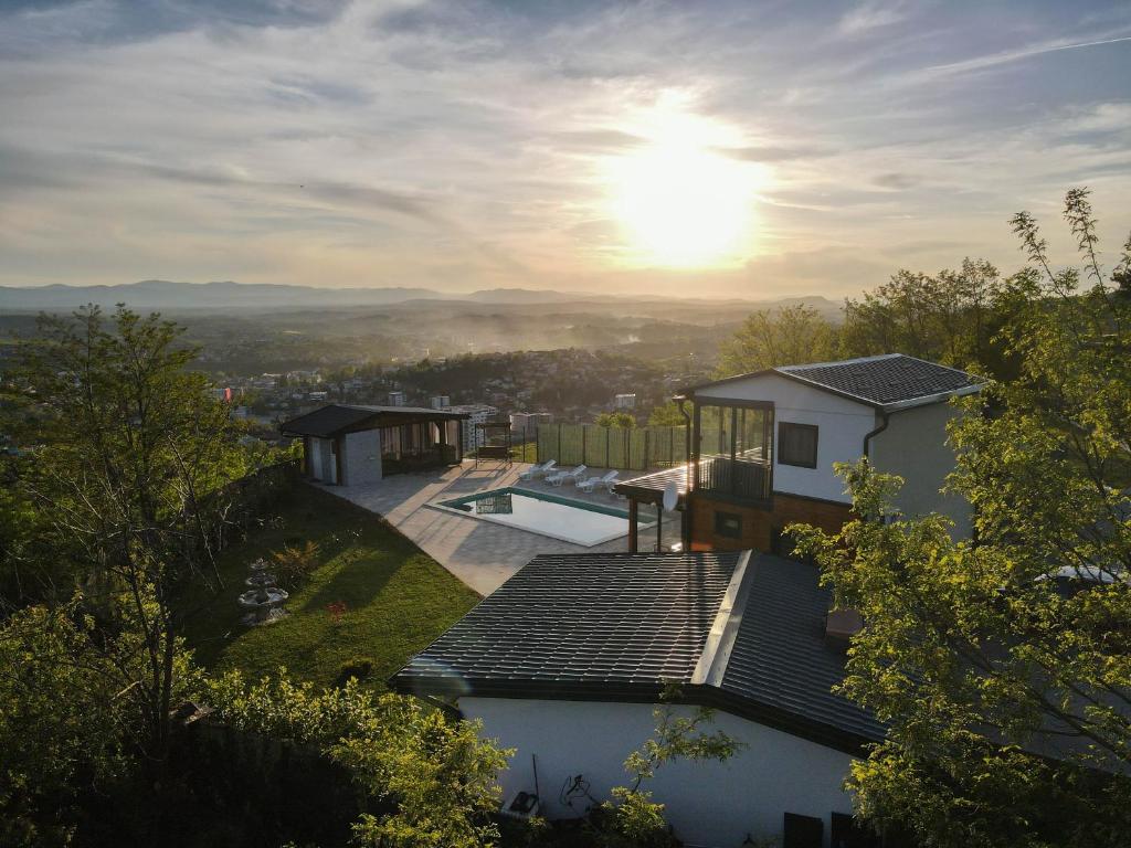 a house with a swimming pool on top of a hill at Vidikovac Cazin in Cazin