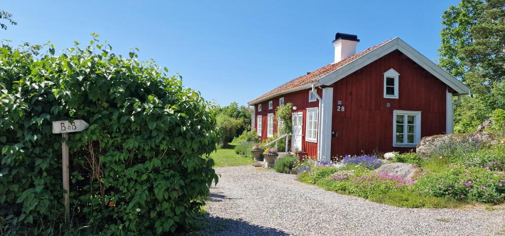 a red house with a sign in front of it at Lillåns B&B in Örebro
