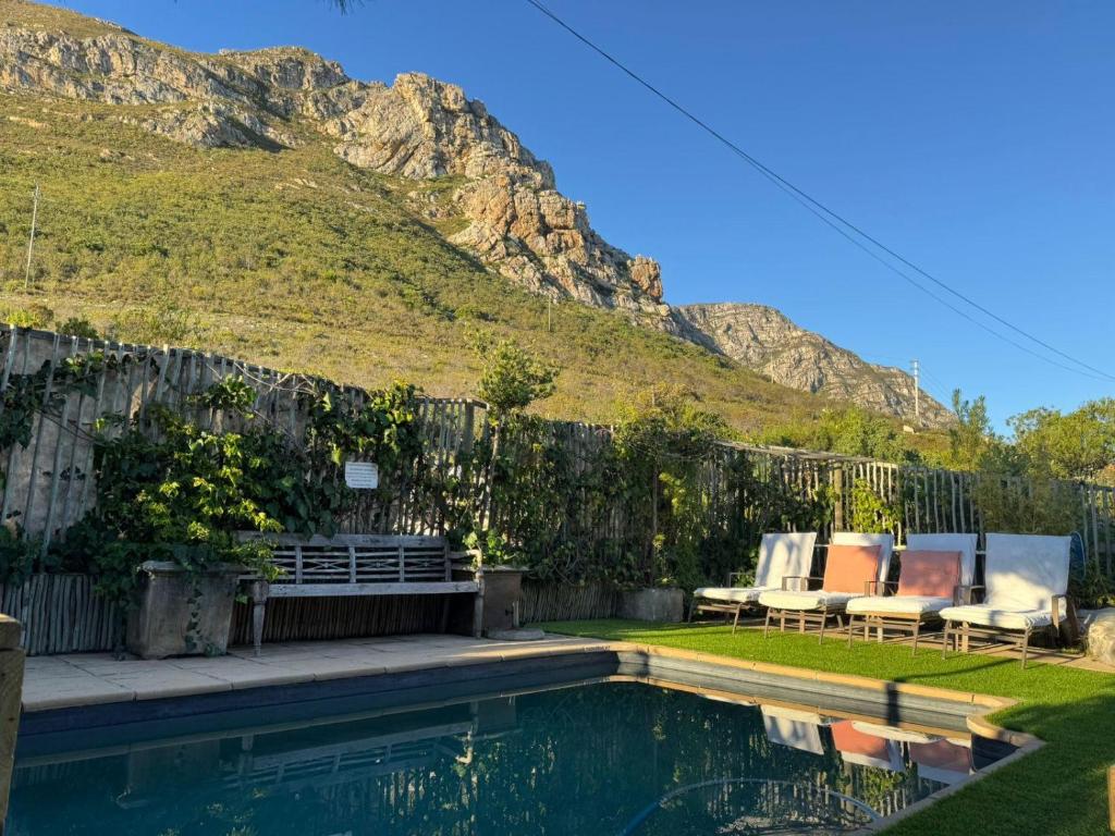 a backyard with a pool with a bench and a fence at 78on5th in Hermanus in Hermanus