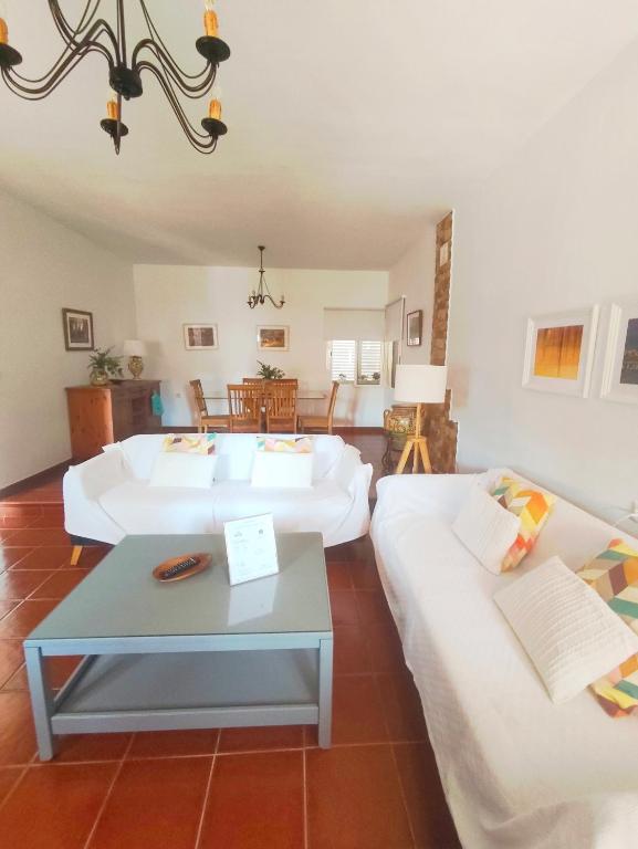 a living room with two beds and a table at Chalet Matalascañas in Matalascañas