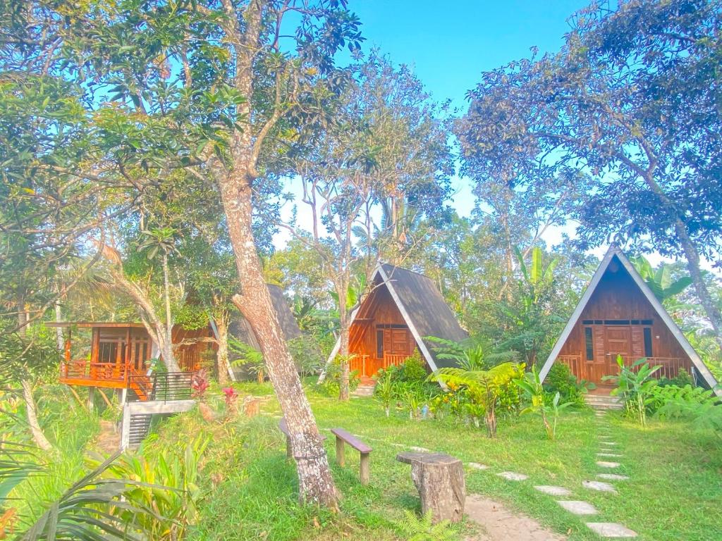 two cottages in the middle of a forest at Forest Side Bungalow in Tetebatu
