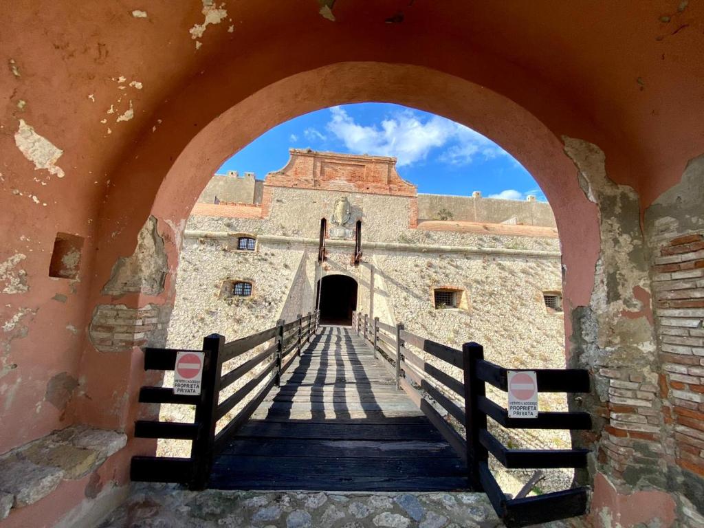 an archway leading to the entrance to a castle at Fortress overlooking the sea in Porto Ercole