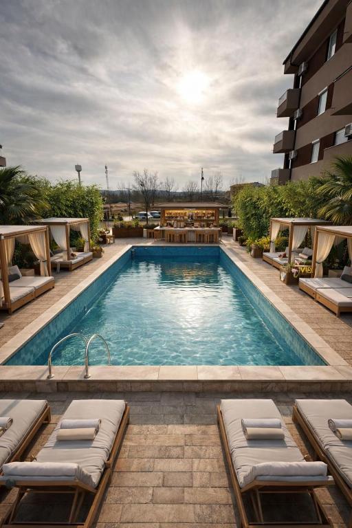 a swimming pool with lounge chairs and a hotel at Apartment with pool in Veliko Gradište