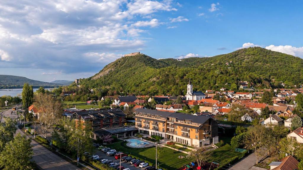 an aerial view of a town in front of a mountain at Hotel Visegrád in Visegrád