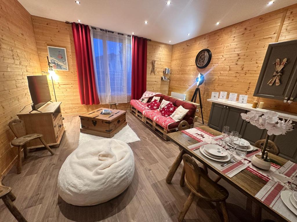 a living room with a couch and a table at L'Appart'Chalet du Revermont in Cousance