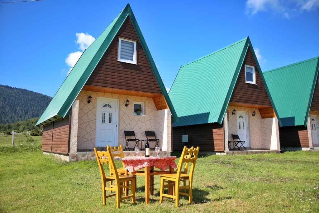 a table and chairs in front of a house at Zekova Valley Cabin Durmitor in Žabljak