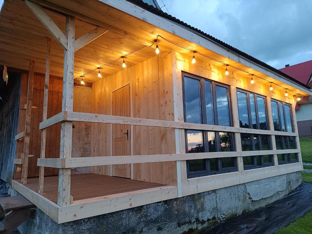 a house with a porch with lights on it at Kowolove in Bańska Wyżna