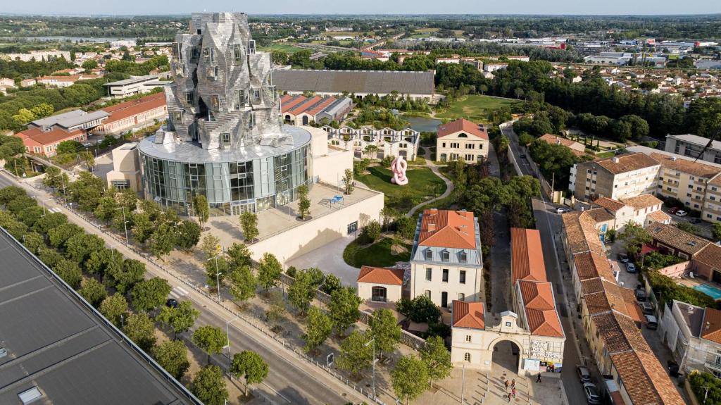 an aerial view of a city with a church at Hôtel du Parc in Arles