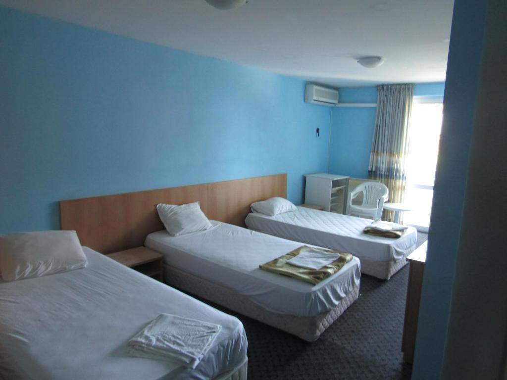 a hotel room with two beds and a window at Hostel Papagal in Varna City