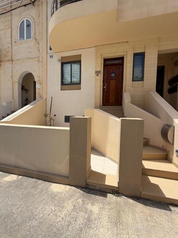 a building with stairs in front of a building at S'Agapo Maisonette St' Julians in St. Julianʼs